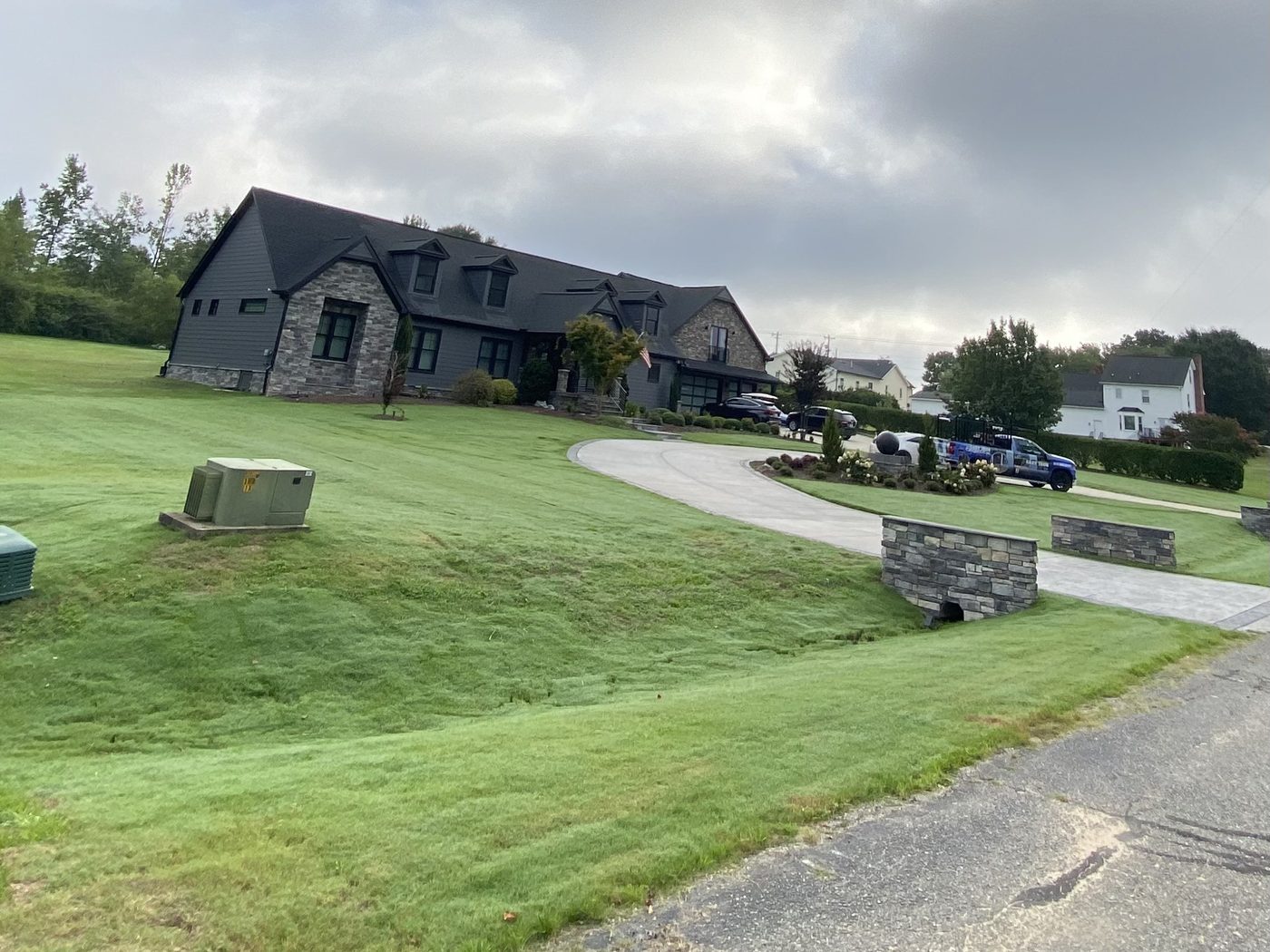 The same slope grown in as a thick green lawn after sod installation and grading